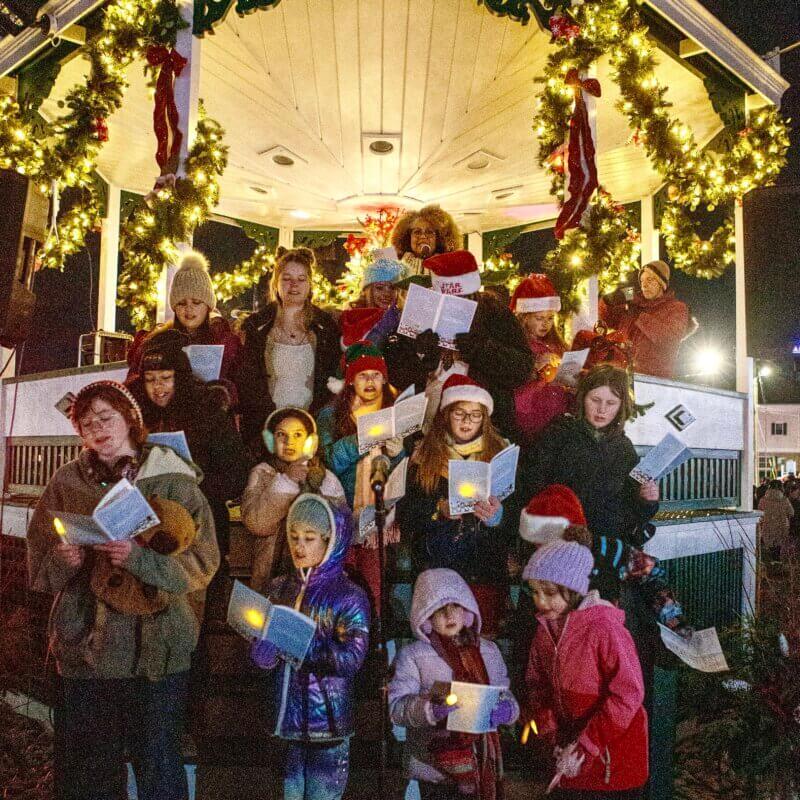 Carol Sing children and leader in the Bandstand